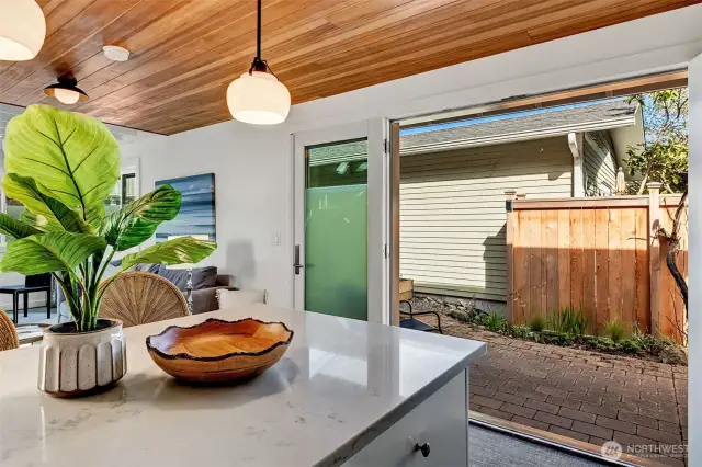 Folding glass doors open onto patio for outdoor dining/entertaining. Let the sun shine in!!