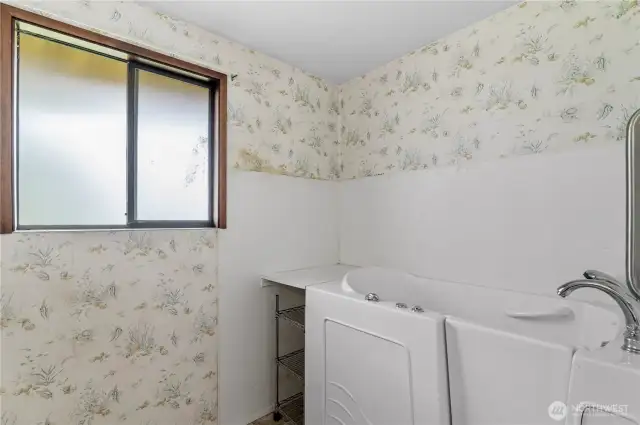 Primary bath with walk in tub.