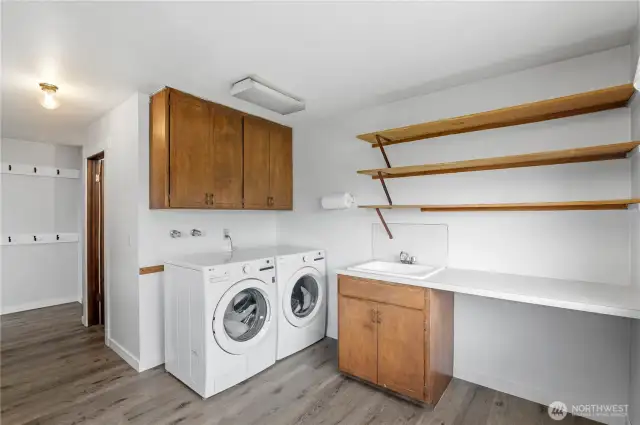 Large laundry room with exterior door to deck.