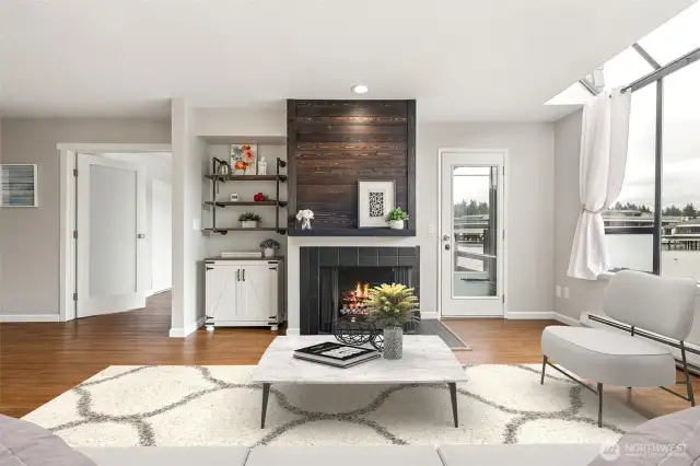 Beautiful accent fireplace, with reclaimed wood on upper part of fireplace, with wood mantel and black painted tile around face. Wood burning.