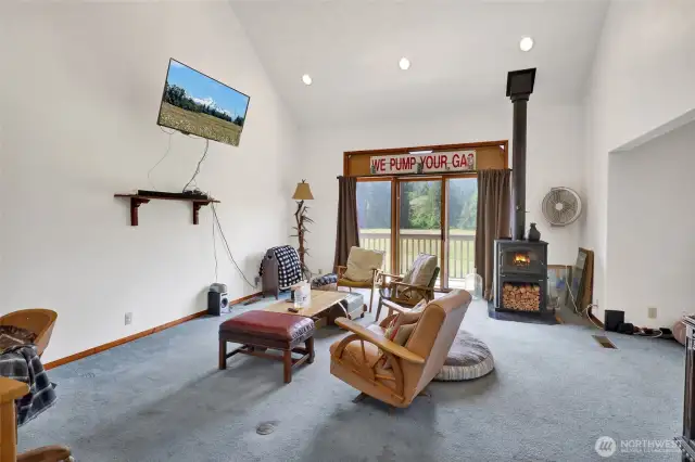 Main floor living room with wood burning fireplace.