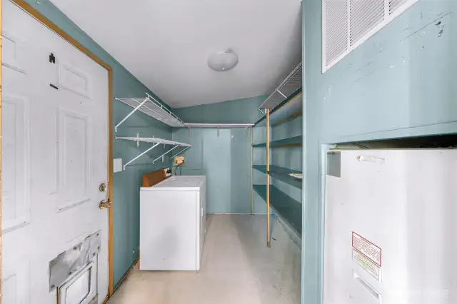 Handy utility room off of kitchen with convenient backdoor access