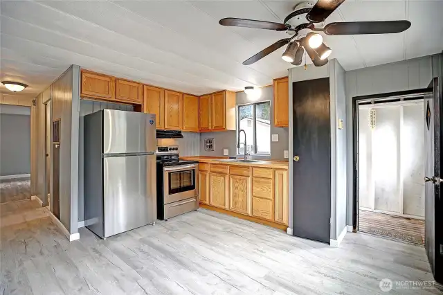 Open concept kitchen with new stainless-steel refrigerator and stove!