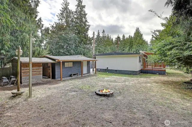 Level backyard with mature trees and fruit trees.