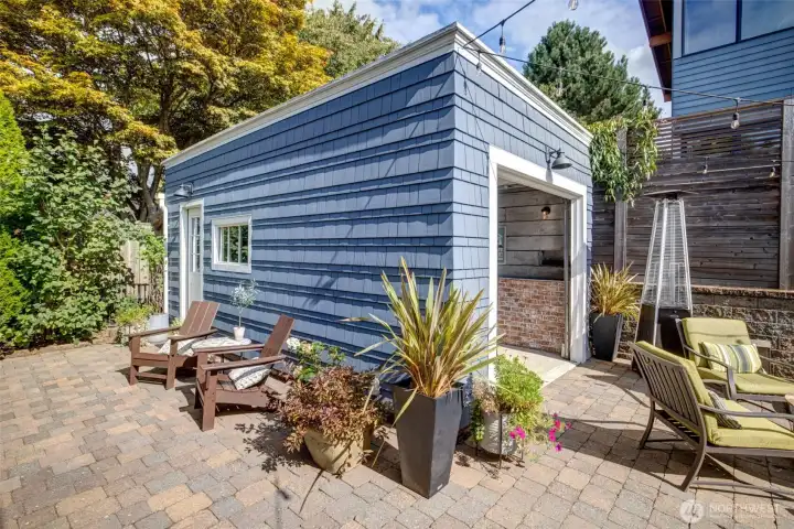 The one-car detached garage was totally re envisioned; half of it is a storage/workshop, and the other half is an entertaining space. Business in the back- party in the front!  It could easily be converted back to a garage, depending on your needs.