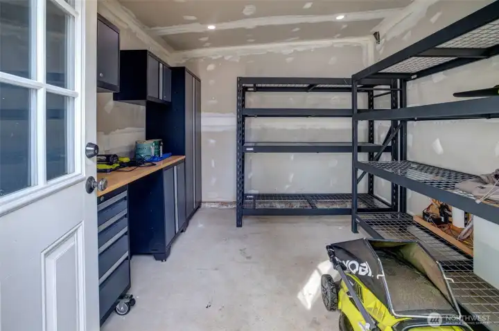 Enviable storage flex workshop space. Yes, the racks and the built-in cabinets stay! This could even be a detached WFH office, art studio, craft space, wood shop, or ????