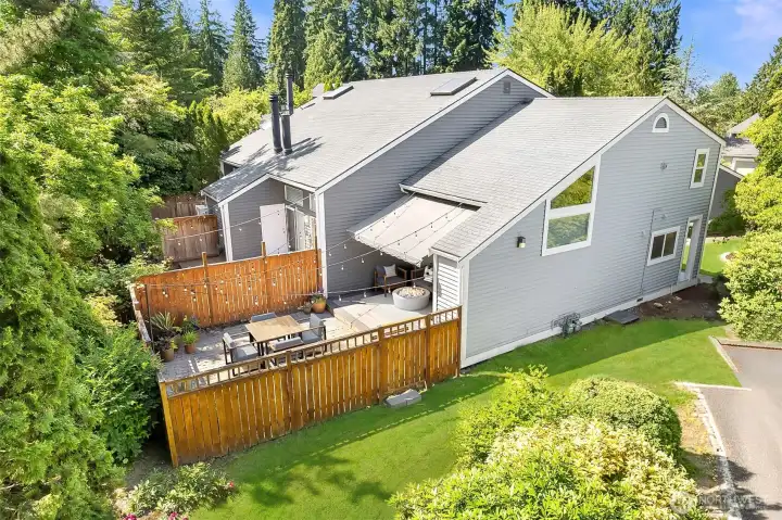 Sun filled lot view of townhouse with yard.  New roof place on unit in Fall of 2025.