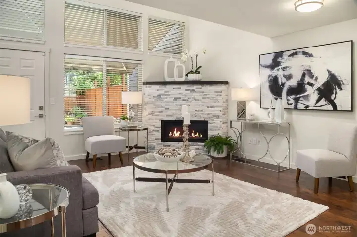 Inside, you're welcomed by soaring ceilings and an abundance of natural light that pours into the cozy yet spacious vamily room.