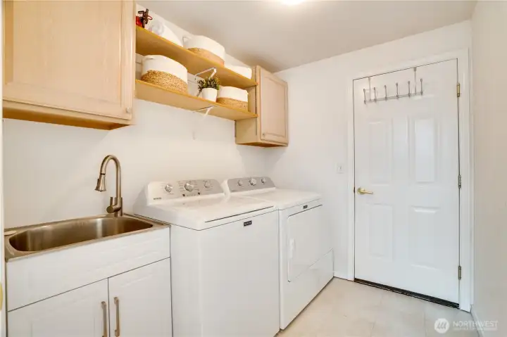 Large utility mud room complete with sink and cabinets to keep things tidy.