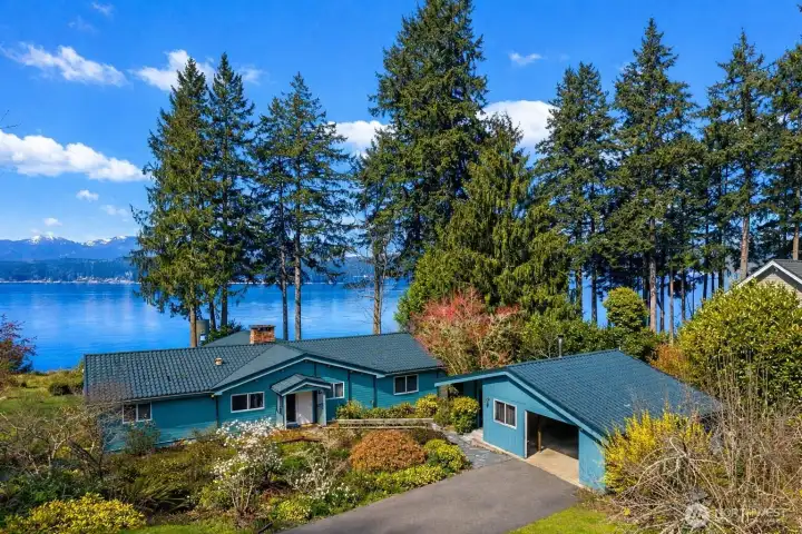 Metal roofs top both the one-story home and the oversized one-car garage, offering durability and showing off prior pride of ownership.