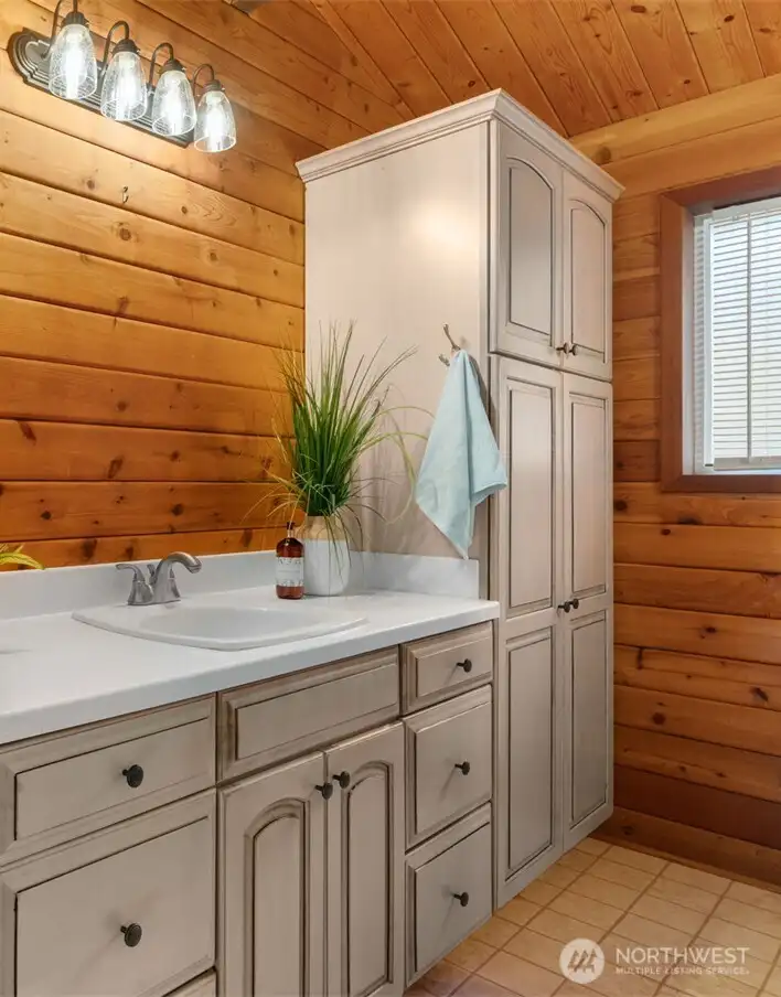 The primary ensuite features newer cabinetry and fixtures, giving the space a fresh, updated feel that’s easy to appreciate.