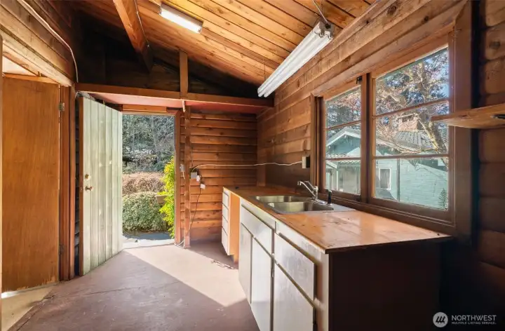 There’s also an adjacent space with a sink, giving you extra room and functionality for projects, hobbies, or just a little extra clean-up before heading inside.