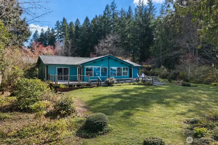 There’s plenty of room for summer gatherings between the house and the waterfront... an inviting stretch of outdoor space that feels made for good conversation, easy laughter, and long afternoons near the water.