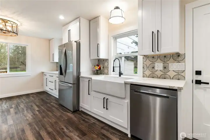 The cabinet to the right of the refrigerator is a hidden trash and recycle cabinet.