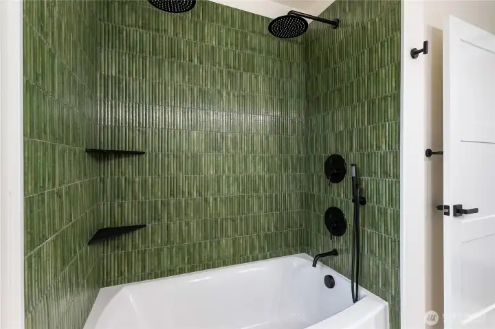 Double shower heads with dual controls and a shower wand.