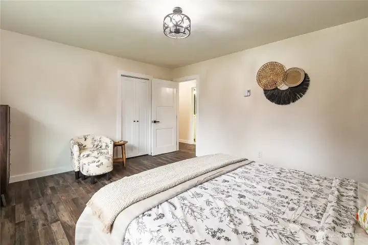 Another angle of the primary bedroom. The door you see (to the left of the entry door)  leads into the closet.