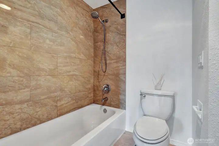 Tile floors and tub surround in the bathrooms      Tiled bath surround and tile floors