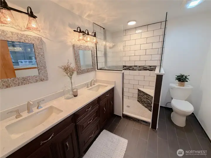 Beautiful primary bathroom with two sinks and a walk-in shower