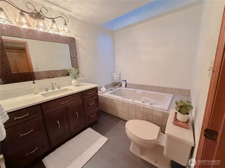 The second bathroom on the main floor comes with a jetted tub