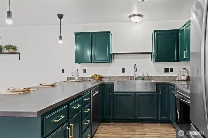 Timeless dark cabinets with gold hardware create a rich modern look as does the deep stainless apron sink. Lots of storage within these cabinets as well as in a separate pantry just around the corner.