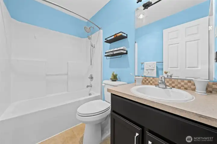 On the upper level is an additional bathroom with a bathtub for soaking.