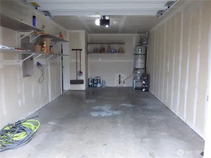 Your attached garage houses the natural gas water heater, with plenty of shelving for storage.