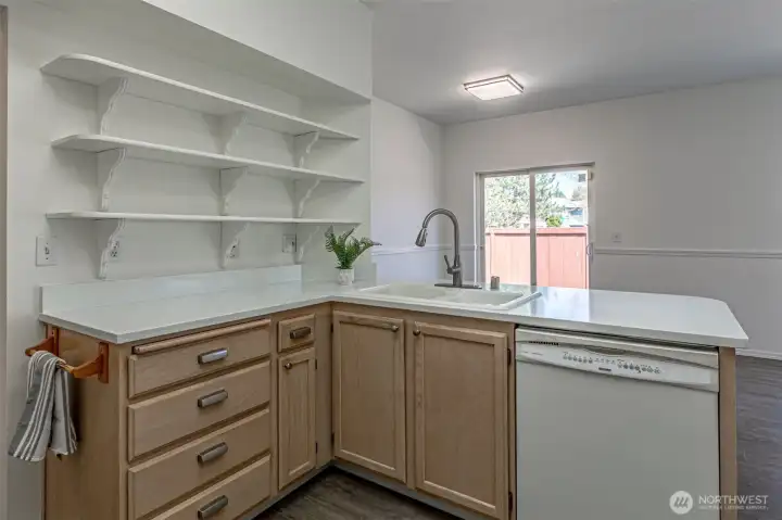 Kitchen with eating bar and slab countertops.