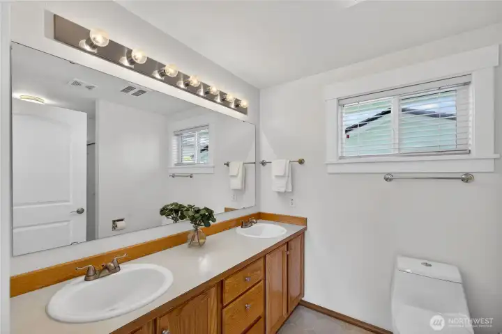 Dual sinks and plenty of light in the primary bathroom. Dual sinks and plenty of light in the primary bathroom.