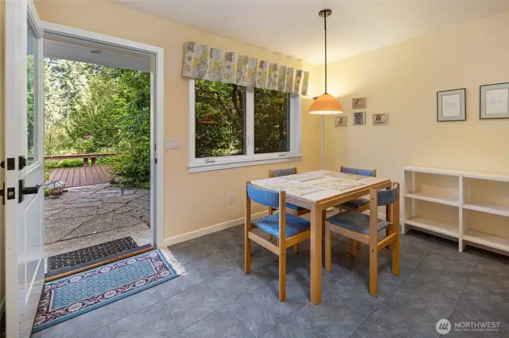 Cheerful dining nook in the guest quarters accommodates four with a warm pendant light, and direct access to the flagstone courtyard, deck and ornamental garden through a charming glass-panelled door. The garden-view window and coordinating fabric valance bring a cottage-like warmth to everyday dining. Cheerful dining nook in the guest quarters accommodates four with a warm pendant light, and direct access to the flagstone courtyard, deck and ornamental garden through a charming glass-panelled door. The garden-view window and coordinating fabric valance bring a cottage-like warmth to everyday dining.