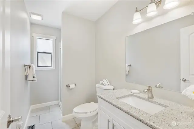 Lower level 3/4 bath has 12x12 tile floors, updated cabinet with soft close drawers & granite countertops