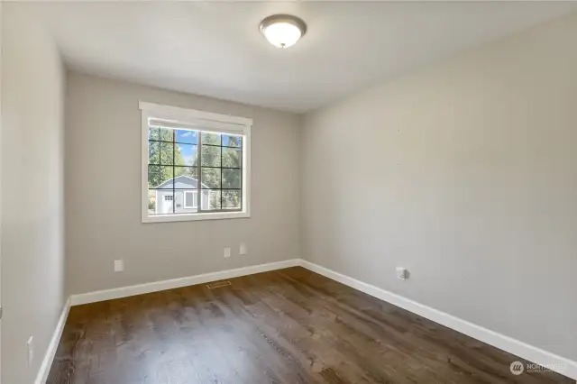 2nd bedroom on upper level has laminate flooring, wood wrapped window & 2" faux wood blinds. Clean and bright