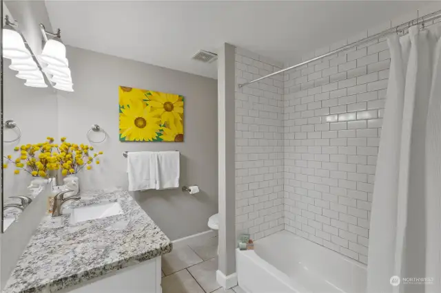 Full bathroom on upper floor has been updated with 12x12 tile floors, large granite countertop, subway tiled shower and soft close cabinets and doors