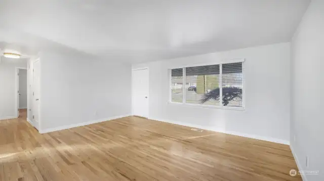 Light shines through the large living room window.