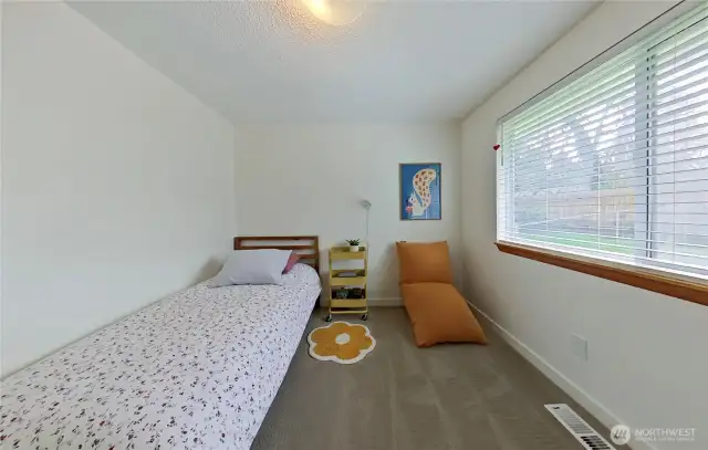 Bedroom 2 - Enjoy comfort and function in this freshly updated bedroom featuring soft new carpet, crisp white trim, and custom shelving inside the closet. Ideal as a quiet retreat, kids’ room, or creative space—ready to fit your lifestyle needs.