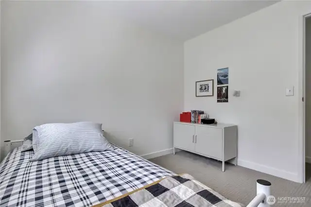 Bedroom 3 - This charming third bedroom is freshly painted with brand new carpet and upgraded closet shelving, offering the perfect blend of comfort and convenience. Tucked away from the main living spaces, it’s a great option for guests or a dedicated work-from-home setup.