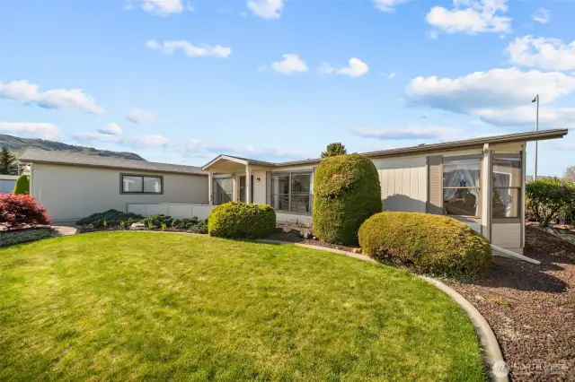 Nice yard with concrete curbing and low maintenance landscaping.