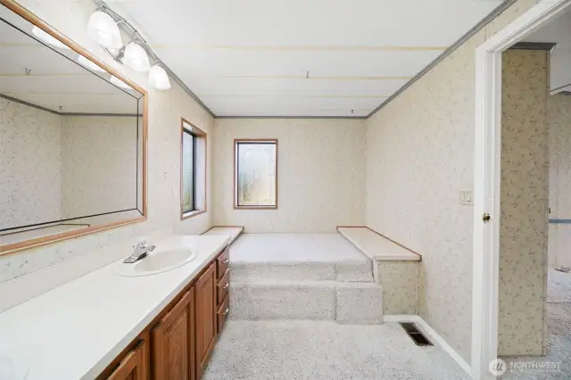 Primary bathroom: bathtub is covered up.