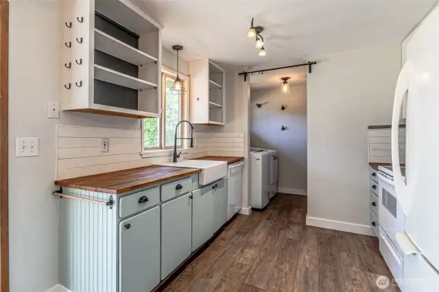 Kitchen view on exterior wall with view into laundry and pantry