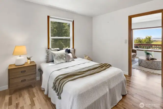 The main level bedroom is spacious and bright