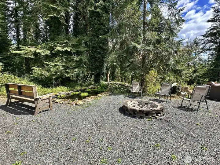 Fire pit is close to fish pond and hot tub.