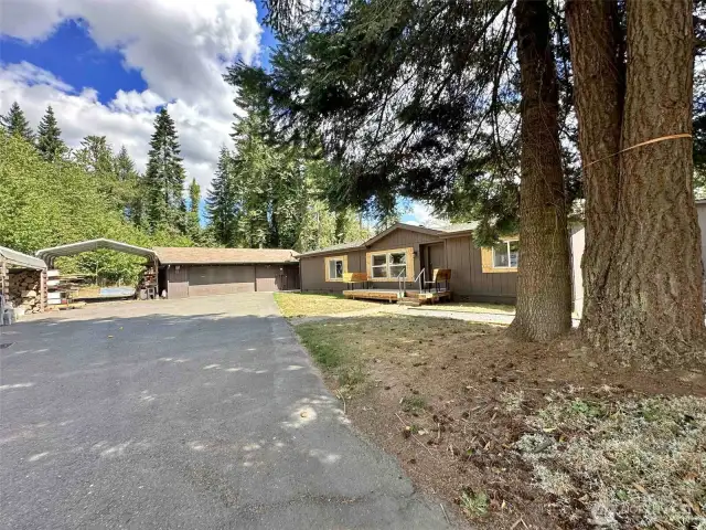 R.V parking. Woodshed. Garage. Surrounded by trees.