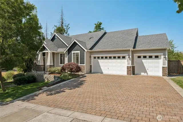 Inviting curb appeal with paver stone driveway and timeless exterior charm on this beautiful Greenwood Estates home.