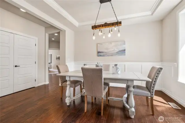 Refined and welcoming dining space just off the entry, highlighted by elegant trimwork and a distinctive chandelier.