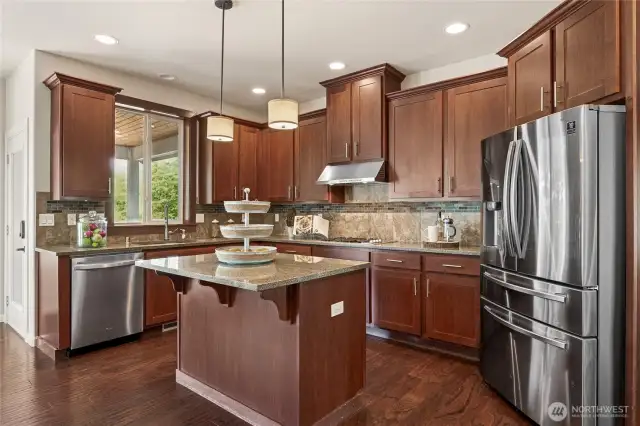 Stylish and functional kitchen with premium finishes, central island, and stainless steel appliances.