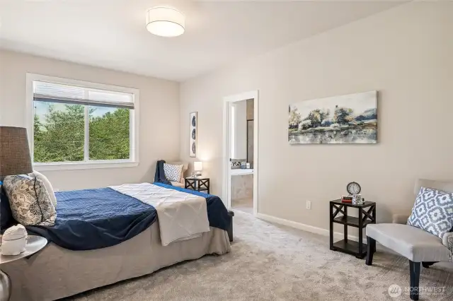 The primary bedroom is a restful retreat with outdoor access and its own elegant ensuite.