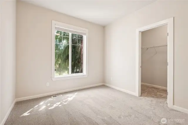 Comfortable main floor bedroom featuring a roomy walk-in closet.