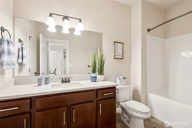 Classic hall bathroom updated with fresh quartz countertops.