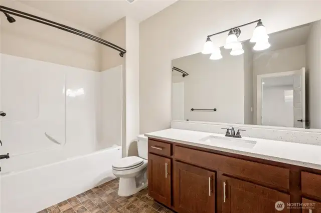 Lower level hall bath with clean, functional design and new quartz counters.
