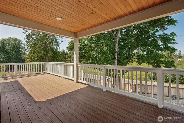 Expansive main floor deck offers open and covered spaces for versatile outdoor living.