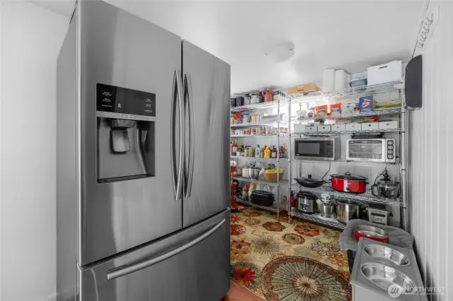 This extra finished room off of the kitchen is amazing for storage.